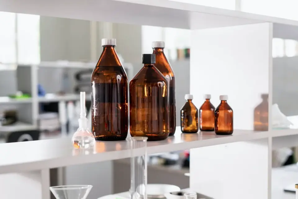 Several dog supplement bottles lined up on a kitchen shelf